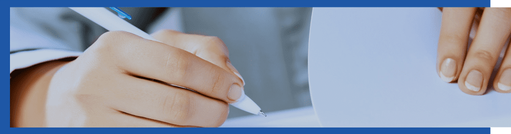 hand with pen ready to sign paperwork